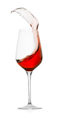 Rose wine splashing in glass on white background
