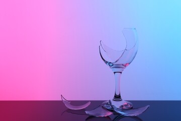 Pieces of broken wine glass on table, space for text. Color tone effect