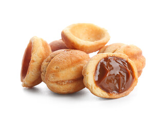 Many sweet walnut shaped cookies with boiled condensed milk on white background