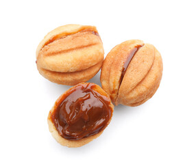 Sweet walnut shaped cookies with boiled condensed milk on white background