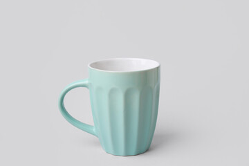Blue ceramic cup on grey background