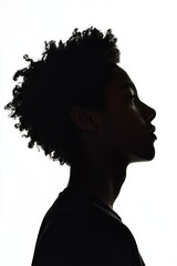 Silhouette of a young person with curly hair