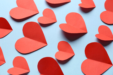 Red paper hearts on blue background. Valentine's Day celebration