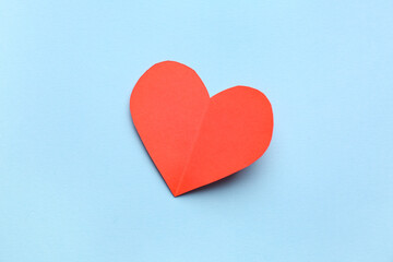 Red paper heart on blue background. Valentine's Day celebration