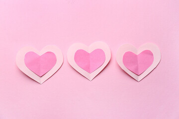 Paper hearts on pink background. Valentine's Day celebration