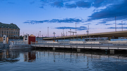 Waterfront bridge at sunset with clouds in new part in the center of Stockholm