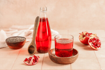 Lemonade with chia seeds and pomegranate on wooden table, closeup