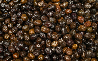 Fresh olives for sale at the market. Black olives, close-up.
