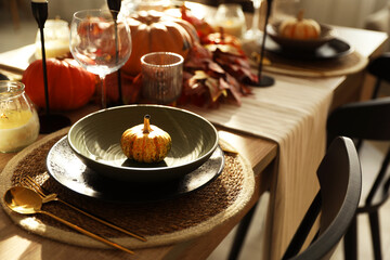 Stylish table setting with beautiful autumn decor in dining room