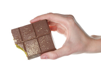 Woman holding piece of Dubai chocolate bar with pistachio and knafeh on white background, closeup
