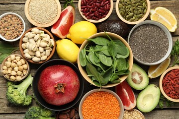 Different superfood products on wooden table, flat lay
