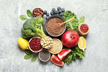 Different superfood products on grey table, flat lay