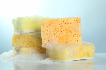 Sponges with foam on light table, closeup