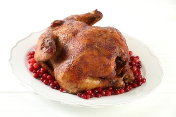 Delicious baked turkey and cranberries on white table, closeup