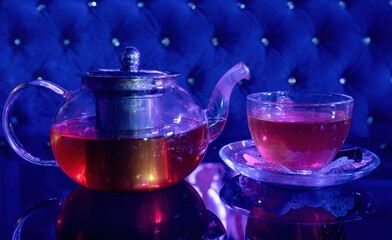 A Cup of freshly brewed black tea,escaping steam,warm soft light, darker background.