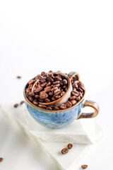 Fresh coffee beans in a mug and background.