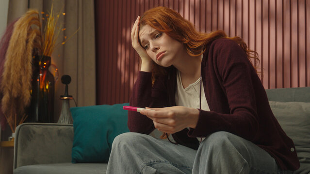 Pregnant young girl Caucasian woman female at home stress unwanted pregnancy check positive or negative result unexpected news shocked worried anxious stressed scary future mother problem infertility