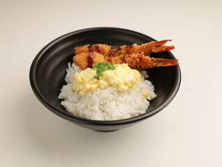 rice with fried shrimp and teriyaki sauce served with egg mayonnaise in black bowl