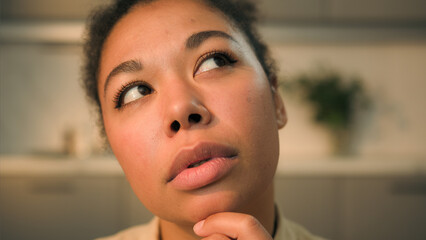 Close up face African American woman disappointed upset alone sorrowful ethnic girl female lady homeowner think problem ponder upset suffer depression worried frustrated grief health trouble at home