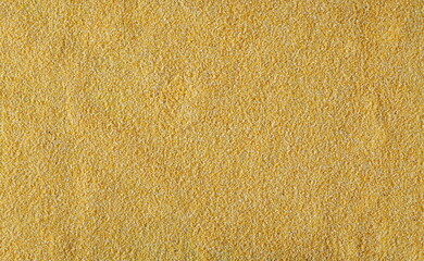 Corn polenta uncooked background and texture, top view	