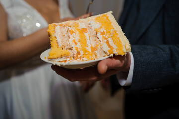 Deliciously Layered Wedding Cake Slice with Creamy Frosting Served on a Plate
