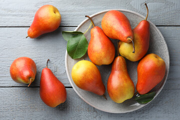 Ripe juicy pears on grey wooden table, flat lay