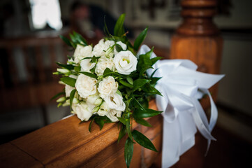 Elegant White Bridal Bouquet with Satin Ribbon on Rustic Wooden Banister