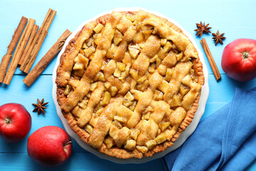 Homemade apple pie and ingredients on light blue wooden table, flat lay