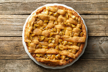 Homemade apple pie on wooden table, top view
