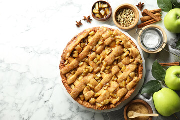 Homemade apple pie and ingredients on white marble table, flat lay. Space for text