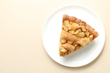 Slice of homemade apple pie on beige background, top view. Space for text