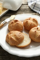 Plate with homemade tasty buns on table, closeup