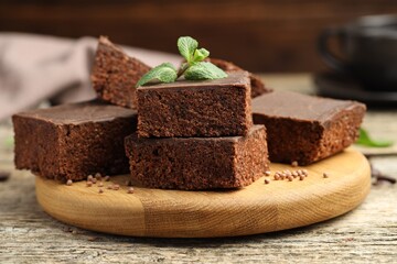 Delicious chocolate puffed rice bars and mint on wooden table, closeup