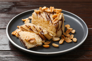 Delicious sweet semolina halva with peanuts on wooden table, closeup