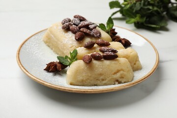 Delicious sweet semolina halva with almonds, spices and mint on white marble table