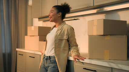 Happy smiling woman African American girl cheerful homeowner renter tenant moving in new own home...
