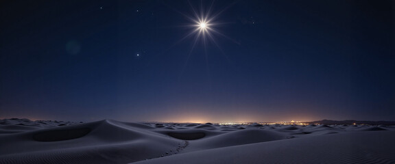 Bright Star of Bethlehem over desert dunes at night