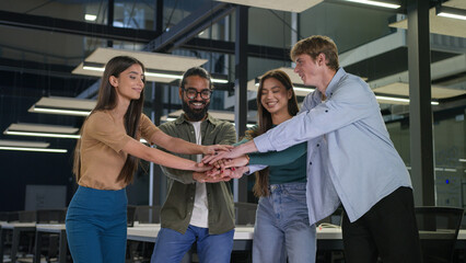 Naklejka premium Happy business women men multiracial friends students group corporate colleagues stacking hands in pile join team gesture unity teamwork support girls guys male female put arms together union victory