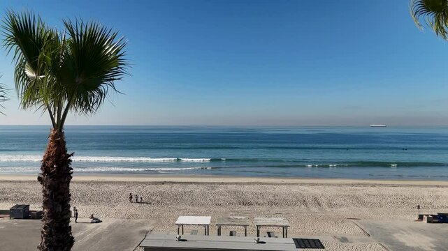 Drone footage of the pacific ocean waves rolling on Coronado Beach in Coronado city, California, USA