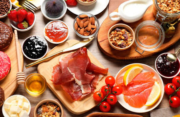 Different tasty food served for brunch on wooden table, flat lay