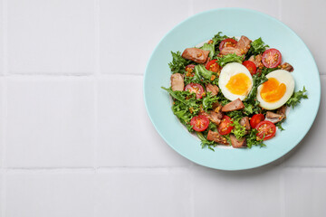 Delicious fresh tuna salad on white tiled table, top view. Space for text