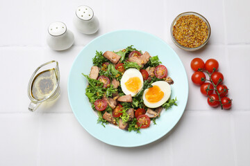 Delicious fresh tuna salad and ingredients on white tiled table, flat lay
