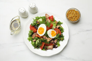 Delicious fresh tuna salad and ingredients on white marble table, flat lay
