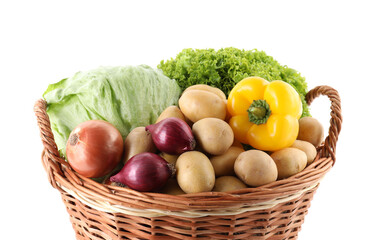 Different ripe vegetables in wicker basket isolated on white