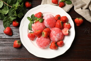 Delicious mochi, strawberries and mint on wooden table, flat lay