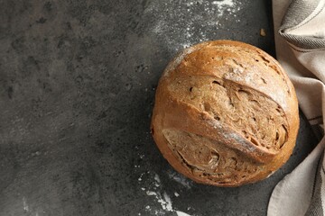 Freshly baked bread on grey table, top view. Space for text