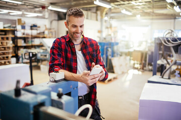 Male factory worker working in industrial printing office