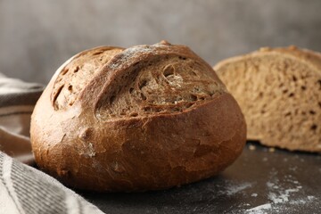 Freshly baked bread on grey table, closeup