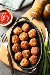 Tasty meatballs served on grey table, flat lay