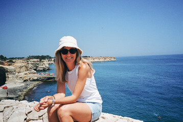 Tourist smiling in torre sant'andrea, puglia, italy, during summer vacation